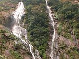 Manaslu 03 02 Waterfalls I walked along the narrow trail making ups and downs and arrived at Khorlabesi (970m) at 10:00. A young bearded Maoist, dressed in a t-shirt and army fatigues, talked to me. I showed him my 'tax form', and he was satisfied. A second Maoist young man obtained tax from another traveler. Just after arriving on the eastern side of the Buri Gandaki, there was a two-streamed waterfall dropping from the heavens.